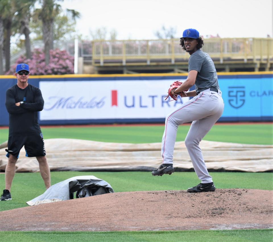 Blue Wahoos 18-year-old touted pitcher Eury Perez goes through a workout Tuesday at Blue Wahoos stadium as pitching coach Dave Eiland looks on.