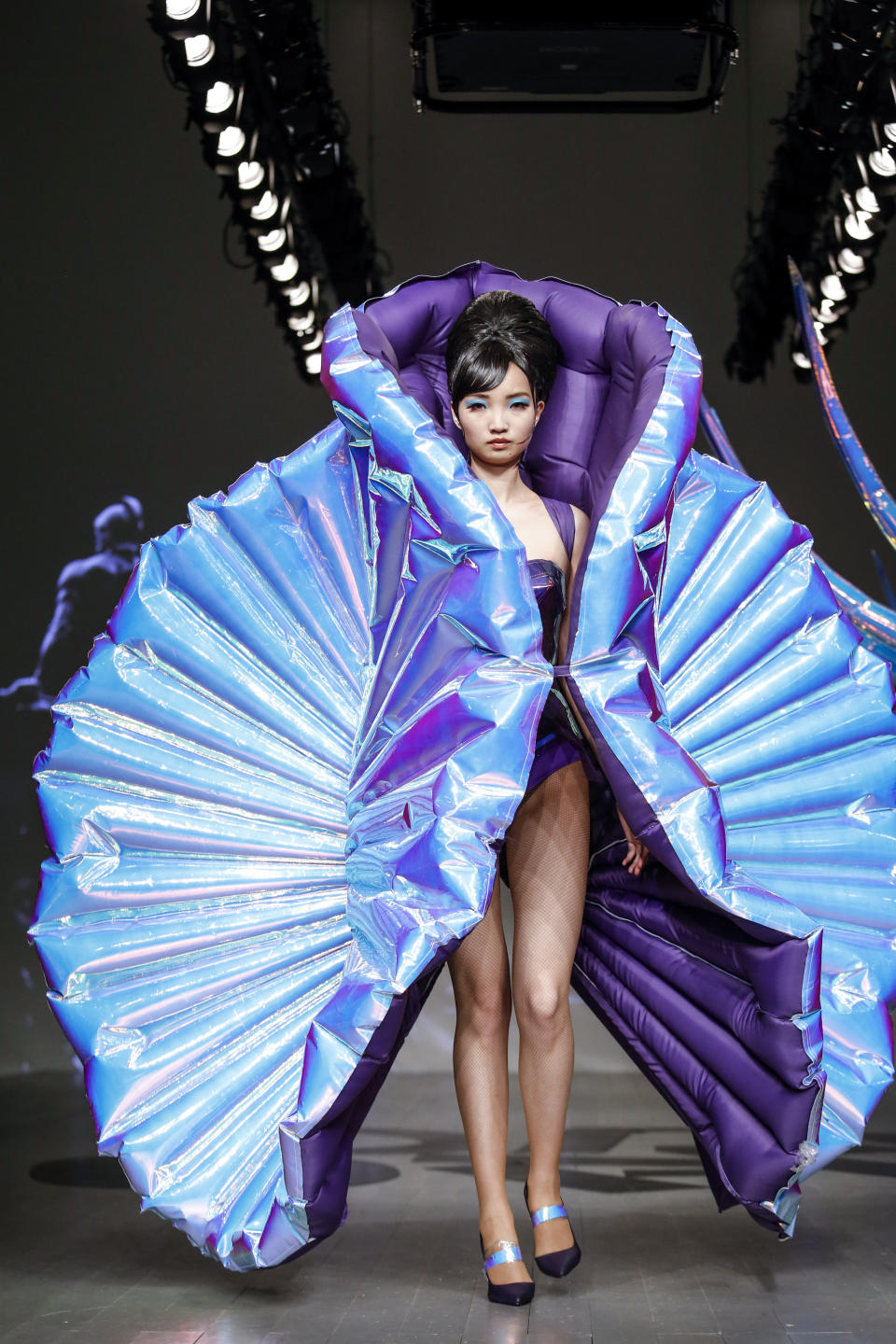 Jack Irving's presentation (which was part of the On|Off Presents portion of London Fashion Week) was all about the drama, as seen here with this holographic seashell-type garment.