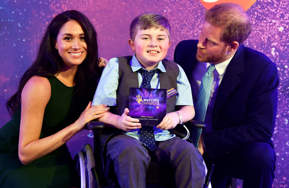 A photo of Prince Harry, Duke of Sussex and Meghan, Duchess of Sussex posing for a photograph with award winner William Magee during the WellChild Awards at Royal Lancaster Hotel on October 15, 2019 in London, England.