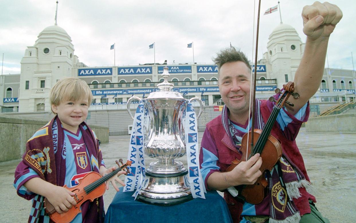 Violinist Nigel Kennedy pictured with his son Stark on Wembley Way in the lead up to the 2000 FA cup final - Hulton Archive/Getty Images