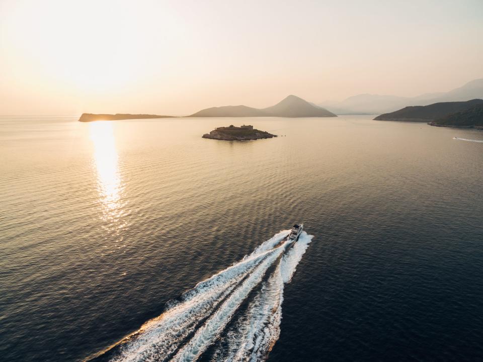 A boat passes near Mamula Island.