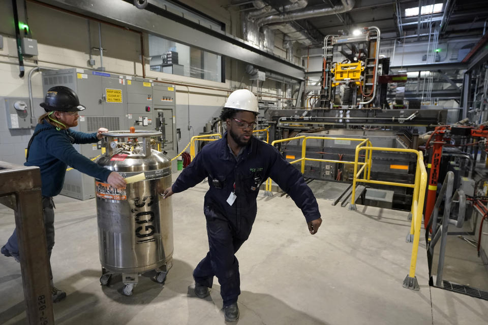 File - Workers transport equipment at Boston Metal on Jan. 25, 2023, in Woburn, Mass. On Friday, the U.S. government issues the August jobs report. (AP Photo/Steven Senne, File)