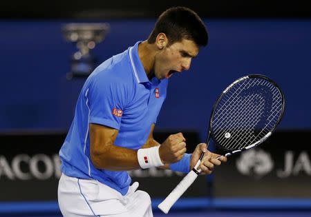 Novak Djokovic of Serbia celebrates winning the third set against Andy Murray of Britain during their men's singles final match at the Australian Open 2015 tennis tournament in Melbourne February 1, 2015. REUTERS/Issei Kato