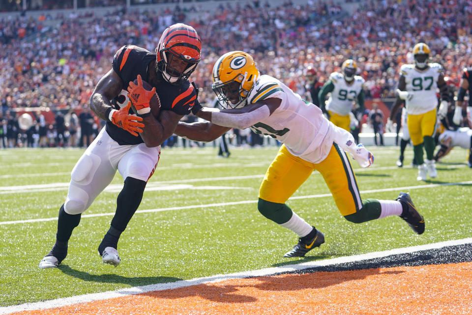 Cincinnati Bengals running back Samaje Perine (34) runs in for a touchdown in front of Green Bay Packers safety Adrian Amos (31) in the first half of an NFL football game in Cincinnati, Sunday, Oct. 10, 2021. (AP Photo/Bryan Woolston)