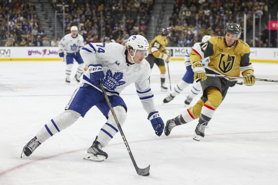 Toronto Maple Leafs center Bobby McMann (74) skates past Vegas Golden Knights left wing Mason Morelli (11) during the first period of an NHL hockey game Thursday, Feb. 22, 2024, in Las Vegas. (AP Photo/Ian Maule)