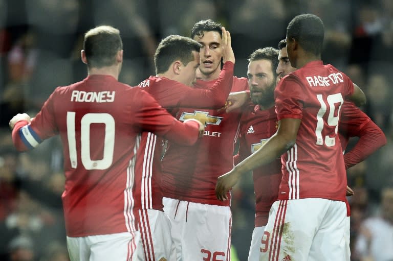 Manchester United's Juan Mata (3rd R) celebrates with teammates after scoring a goal during their League Cup semi-final first leg match against Hull City, at Old Trafford in Manchester, on January 10, 2017