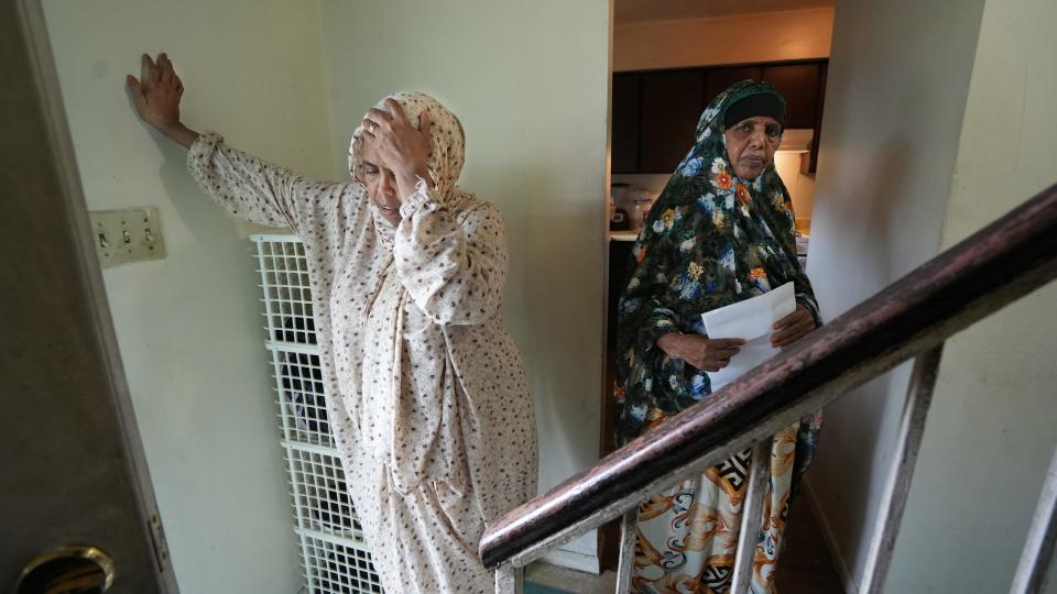 Farhiya Ali (left) is exasperated with the lack of maintenance at the apartment of her aunt, Fadumo Dirir (right), at the Carriage House apartments on the Northeast Side.