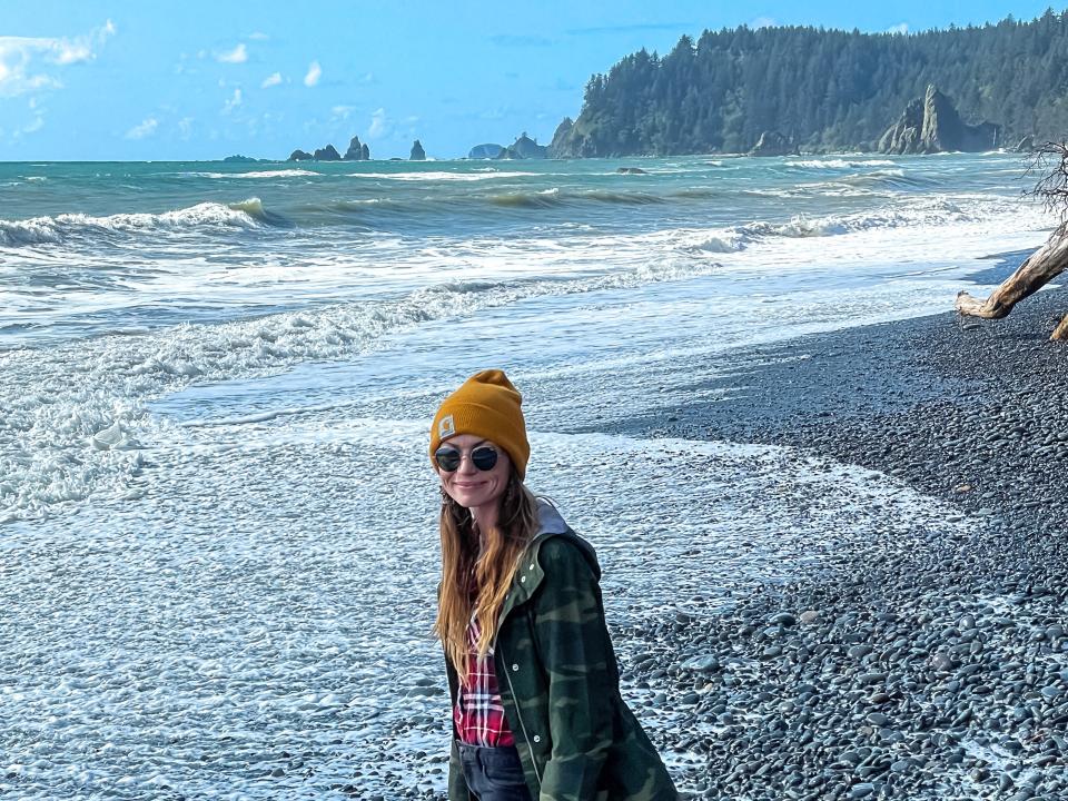 Emily walking along a rocky beach in Olympic National Park.