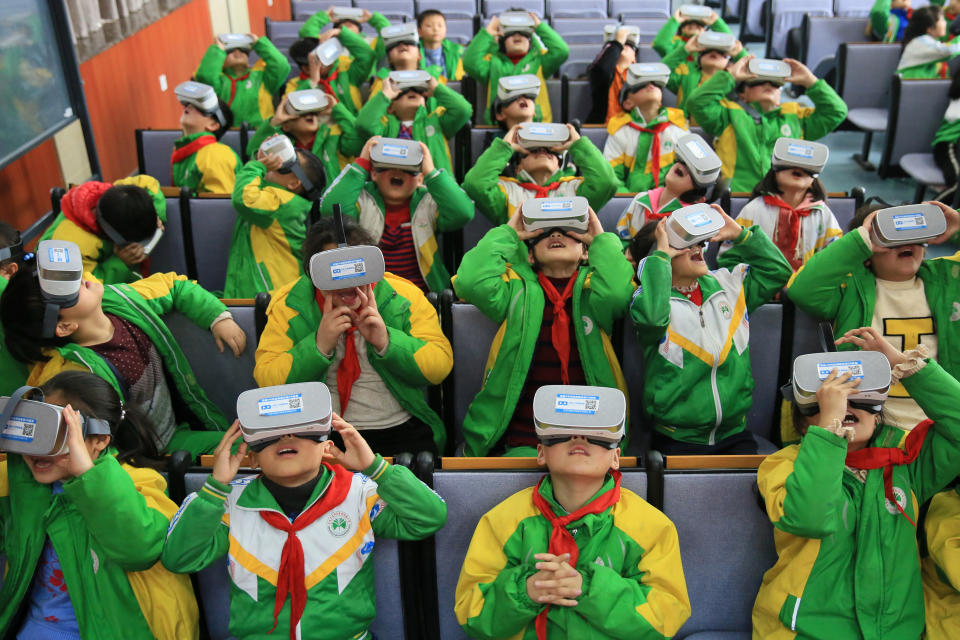 XIANGXI, CHINA - MARCH 14:  Primary school students wear virtual reality glasses while learning about science in a classroom on March 14, 2018 in Xiangxi Tujia and Miao Autonomous Prefecture, Hunan Province of China. Virtual reality technology helps these primary school students better explore the secret of nature.  (Photo by Visual China Group via Getty Images/Visual China Group via Getty Images)