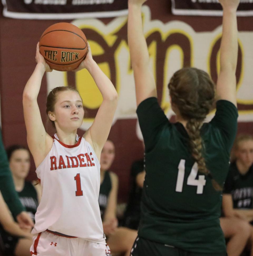 Red Hook's Liv Christensen looks to make a pass over Cornwall's Emily Olsen during a December 14, 2023 girls basketball game.