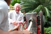 <p>Charles operates a sugar cane press during a visit to a paladar, a private restaurant [Photo: Getty] </p>