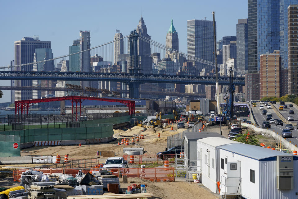 Framed by the Manhattan bridge and the downtown skyline, construction continues on the East Side Coastal Resiliency Project at the East River Park, Friday, Oct. 7, 2022, in New York. (AP Photo/Mary Altaffer)