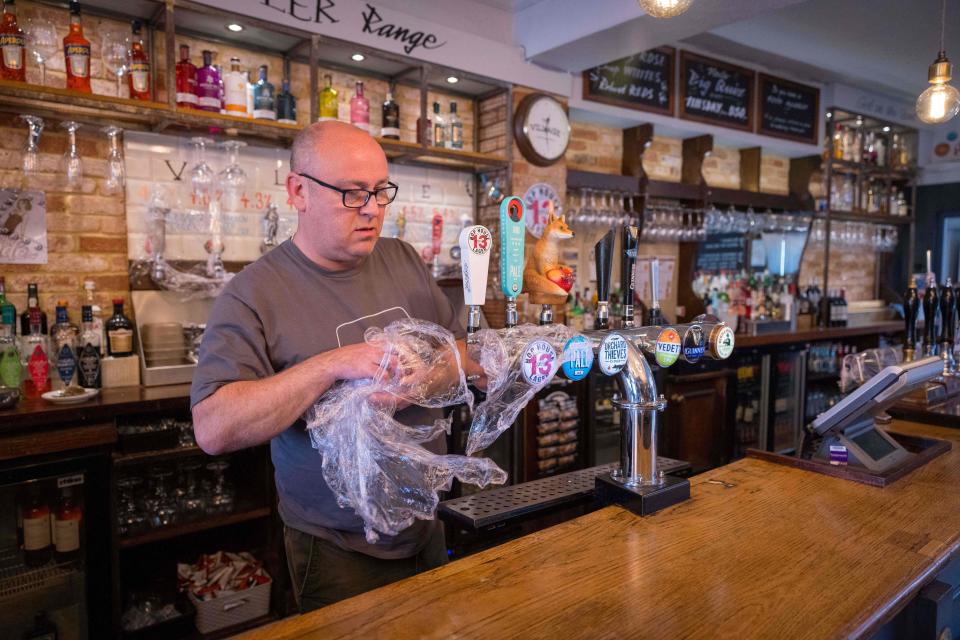 Carl Elliott, manager of The Village Pub, at his pub in Walthamstow, northeast London as he prepares for partial re-opening on 12 April. Photo: Tolga Akmen/AFP via Getty Images