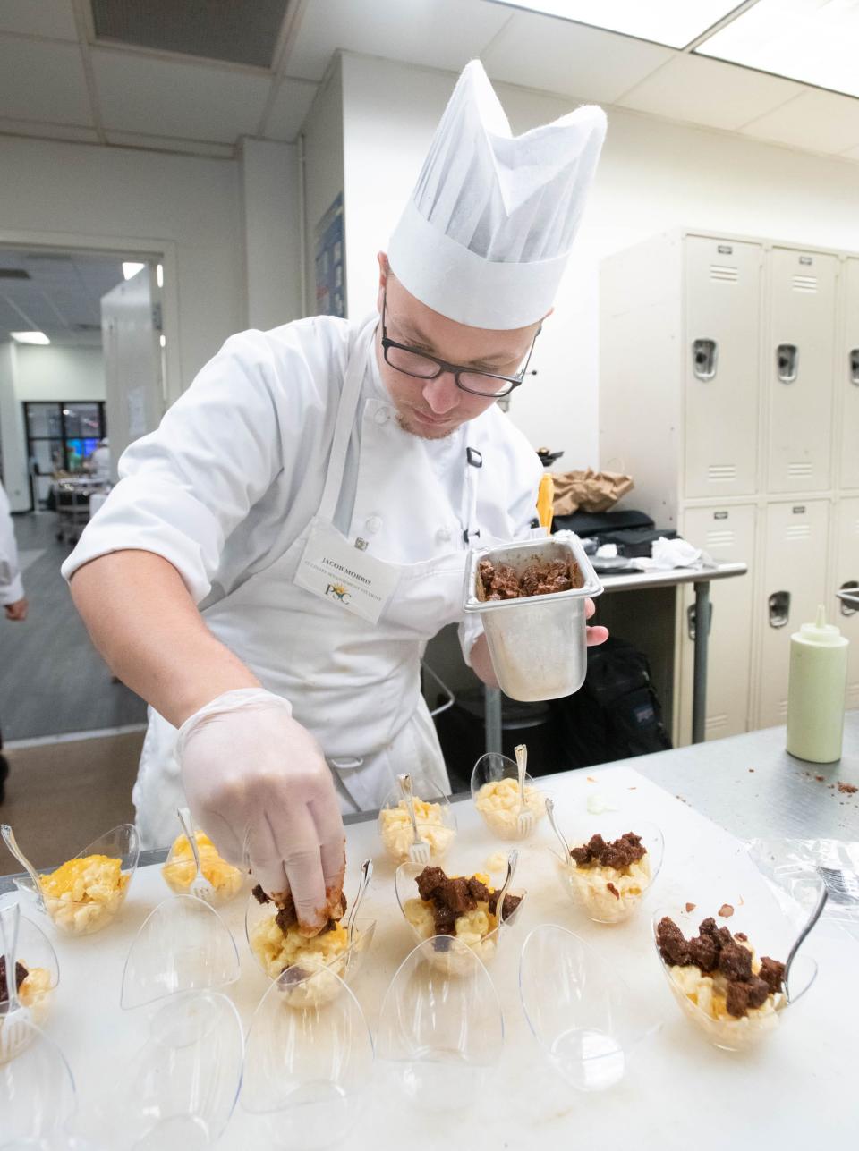 Jacob Morris prepares smoked brisket mac and cheese for the Garde Manger donor appreciation reception in the Molly McGuire School of Culinary Arts and Hospitality Programs at Pensacola State College in Pensacola on Wednesday, July 19, 2023.