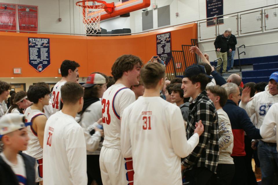 New Hartford celebrates after its 69-60 win over Troy in the Class A Subregionals.