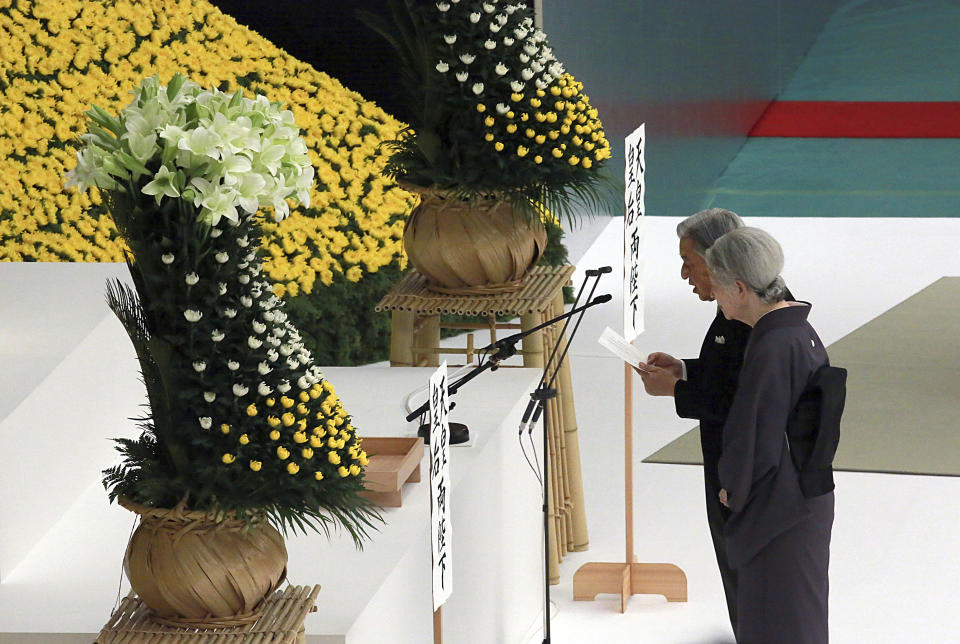 FILE - In this Aug. 15, 2018, file photo, Japan's Emperor Akihito delivers his remarks with Empress Michiko during a memorial service at Nippon Budokan martial arts hall in Tokyo. Japan’s Emperor Akihito has devoted his 30-year reign to making amends for a war fought in his father’s name, while adapting the 1,500-year-old monarchy’s traditions to draw the Imperial Family closer to the public. Akihito’s subtle public comments and insights from his classmates show him to be determined but also open to new ideas. He’s shown a keen awareness of his duties. (AP Photo/Eugene Hoshiko, File)