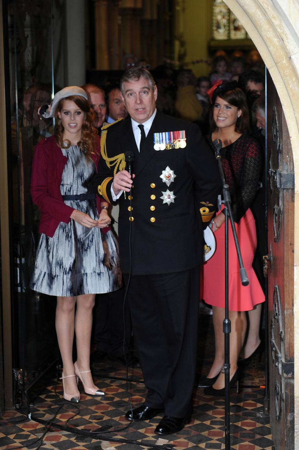 LONDON, ENGLAND - JUNE 03: Prince Andrew, Duke of York (C) with his daughters Princess Beatrice (L) and Princess Eugenie (R) attend the 'Big Jubilee Lunch' at All Saints Church in Fulham ahead of the Diamond Jubilee River Pageant on June 3, 2012 in London, England. For only the second time in its history the UK celebrates the Diamond Jubilee of a monarch. Her Majesty Queen Elizabeth II celebrates the 60th anniversary of her ascension to the throne. Thousands of well-wishers from around the world have flocked to London to witness the spectacle of the weekend's celebrations. The Queen along with all members of the royal family will participate in a River Pageant with a flotilla of a 1,000 boats accompanying them down The Thames. (Photo by Matt Grayson - WPA Pool/Getty Images)