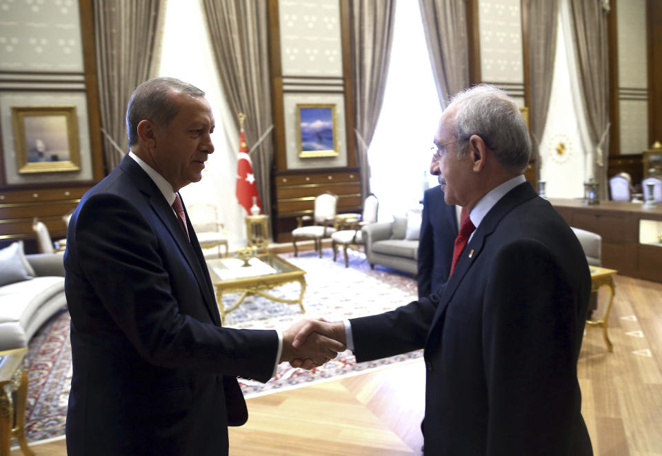 FILE - Turkey's President Recep Tayyip Erdogan, left, greets Kemal Kilicdaroglu, leader of the main opposition Republican People's Party, CHP, before a meeting in Ankara, Turkey, Monday, July 25, 2016. The main challenger trying to unseat Erdogan in the May 14 presidential election cuts a starkly different figure than the incumbent who has led the country for two decades. As the polarizing Erdogan has grown increasingly authoritarian, Kilicdaroglu has a reputation as a bridge builder and vows to restore democracy. (Kayhan Ozer/Turkish Presidency via AP, File)