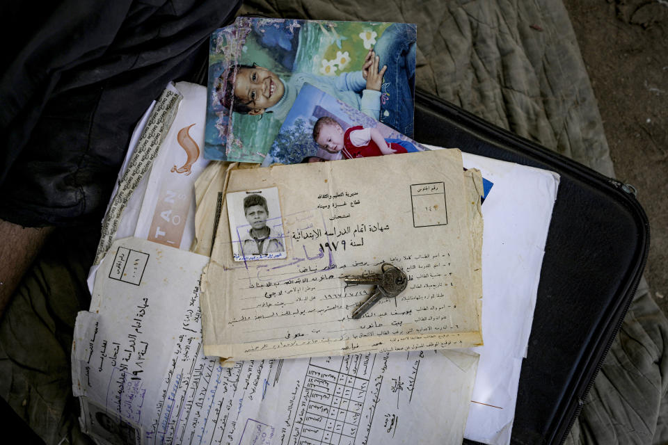 Documents belong to Palestinian Omar Fayad, who was displaced by the Israeli bombardment of the Gaza Strip, are seen at a makeshift tent camp in Deir al-Balah, central Gaza Strip, Monday, July 8, 2024. Over nine months of war between Israel and Hamas, Palestinian families in Gaza have been uprooted repeatedly, driven back and forth across the territory to escape the fighting. Each time has meant a wrenching move to a new location and a series of crowded, temporary shelters. (AP Photo/Abdel Kareem Hana)