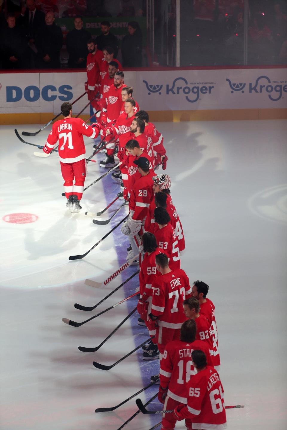 Detroit Red Wings center Dylan Larkin (71) high-fives teammates after being introduced before the season opener against the Tampa Bay Lightning at Little Caesars Arena Thursday, Oct.  14, 2021.