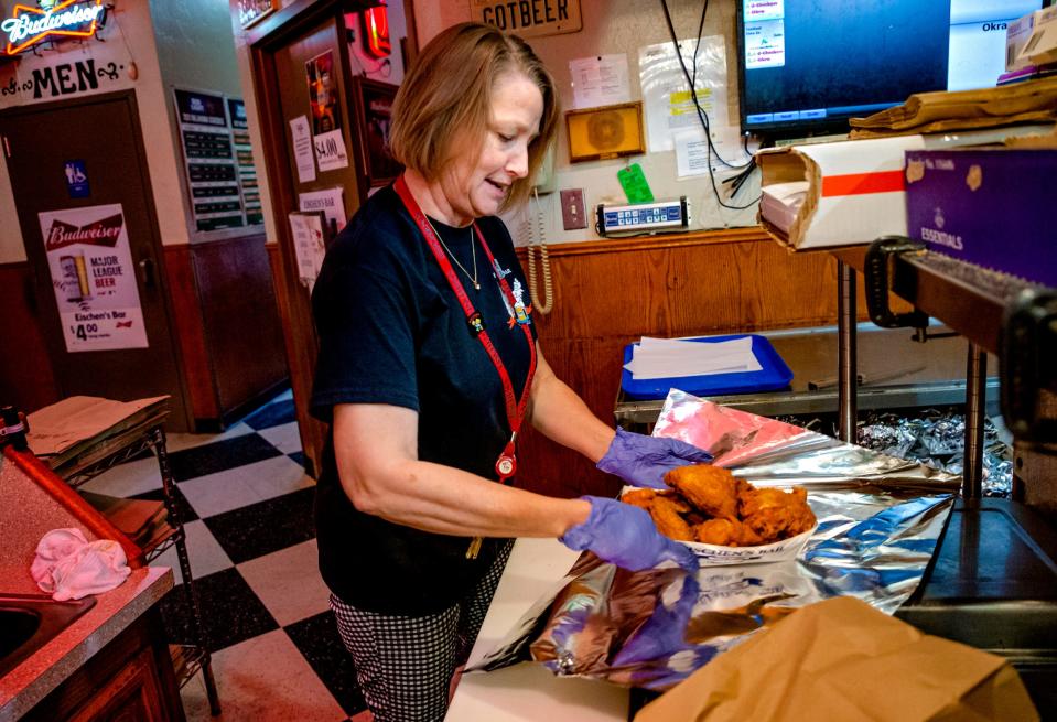 Debbie Brown assembles at to-go order of fried chicken at Eischen's Bar in Okarche, Okla. on Friday, Oct. 1, 2021. Brown is part of the fifth generation of Eischens that are running the iconic restaurant. 