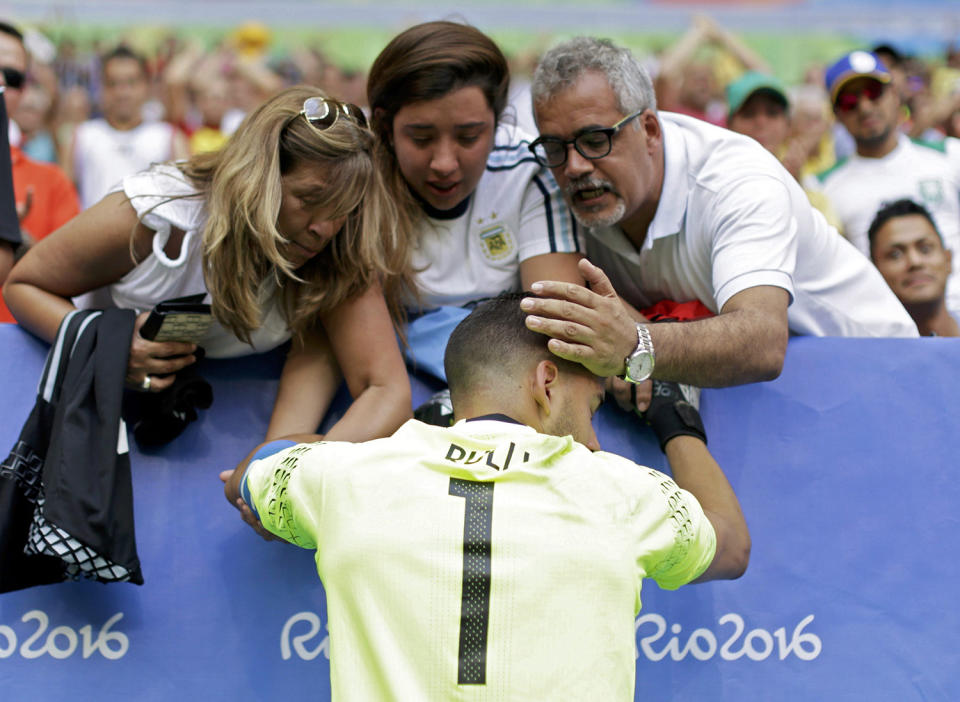 <p>Goalkeeper Geronimo Rulli of Argentina is consoled as he cries after their match as Argentina is eliminated from the Rio Olympics soccer tournament on August 10, 2016. (REUTERS/Ueslei Marcelino) </p>