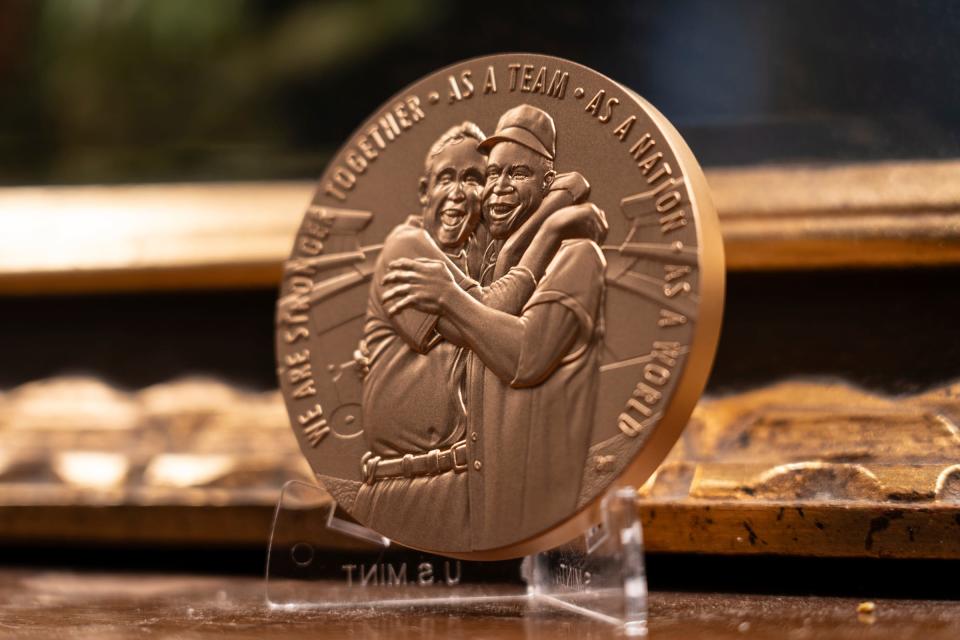 This replica Congressional Gold Medal resembles the one awarded to Cleveland Indians player Larry Doby. It includes a photo of Doby and teammate Steve Gromek from the 1948 World Series following Doby's deciding home run. In 1947 Doby had become the first Black player in the American League, only 11 weeks after Jackie Robinson integrated Major League Baseball.
The wire photo of the hug was available nationwide, but some papers refused to run it, and when Steve Gromek came home, some of his old friends wouldn't talk to him.