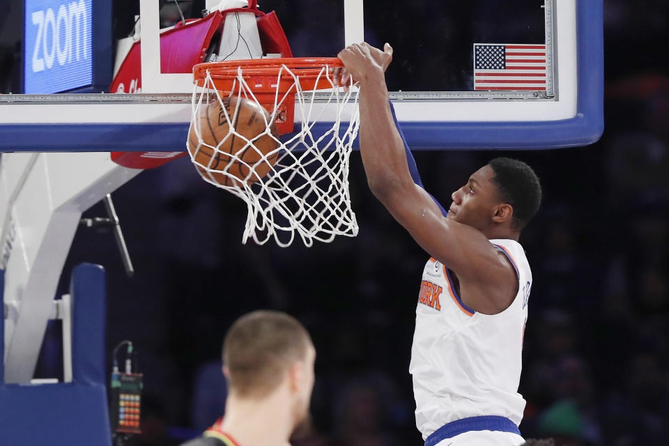 New York Knicks forward RJ Barrett, right, dunks in front of Atlanta Hawks center Alex Len, lower left, during the first half of an NBA basketball game in New York, Tuesday, Dec. 17, 2019. (AP Photo/Kathy Willens)