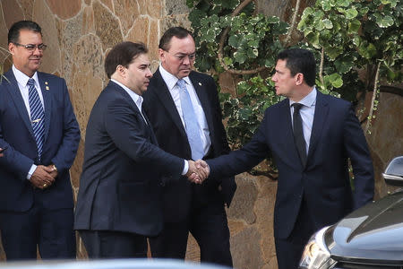 Brazil's Lower House President, Rodrigo Maia and Justice Minister Sergio Moro shake hands after a breakfast in Brasilia, Brazil February 4, 2019. Antonio Cruz/Agencia Brasil/Handout via REUTERS