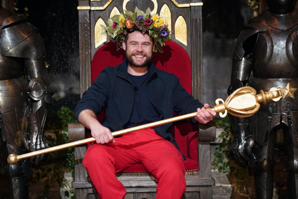 Danny Miller on a throne in a crown