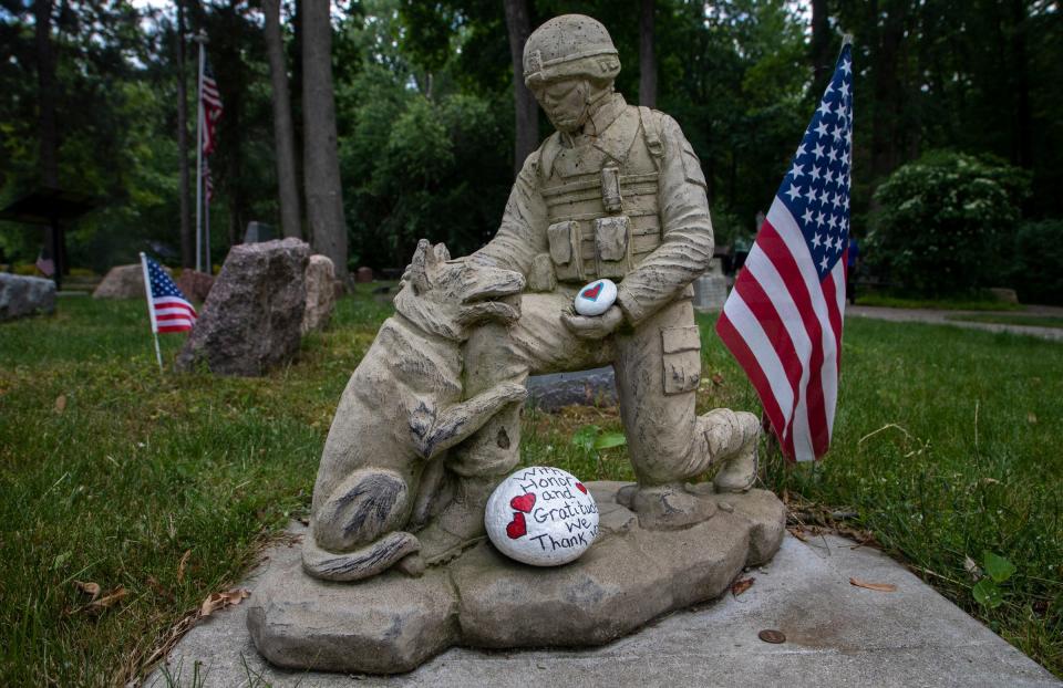 A small statue of a soldier petting a dog sits inside the Michigan War Dog Memorial in South Lyon on  June 14, 2023.