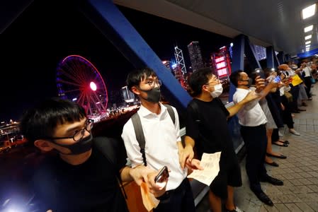 Protesters hold hands to form a human chain during a rally to call for political reforms in Hong Kong's Central district