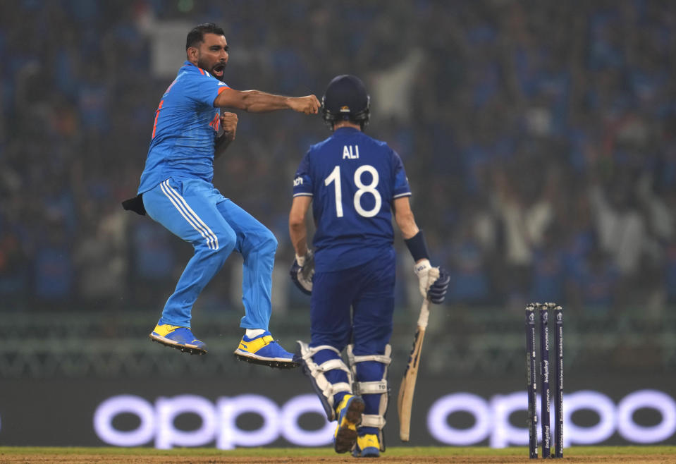 India's Mohammed Shami, left, celebrates the wicket of England's Moeen Ali , right, during the ICC Men's Cricket World Cup match between India and England in Lucknow, India, Sunday, Oct. 29, 2023. (AP Photo/Manish Swarup)