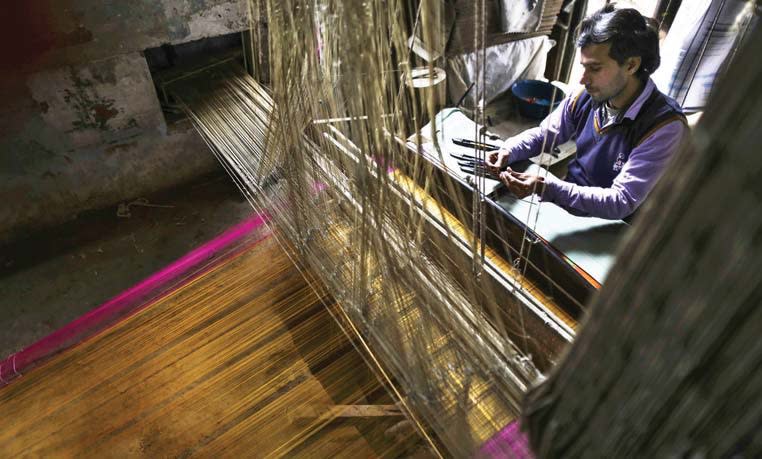 A weaver at a workshop in India. Before you start a business, do as much research as possible on the current market sentiment and the operational challenges.