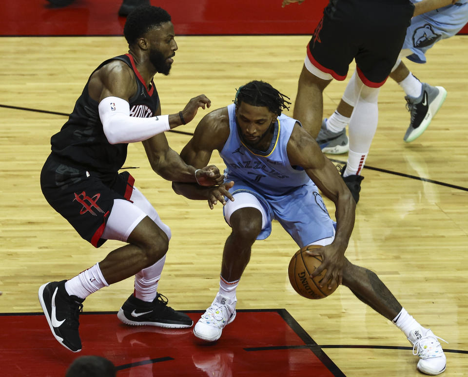 Memphis Grizzlies forward Justise Winslow (7) dribbles as Houston Rockets guard David Nwaba (2) defends during the fourth quarter of an NBA basketball game Sunday, Feb. 28, 2021, in Houston. (Troy Taormina/Pool Photo via AP)