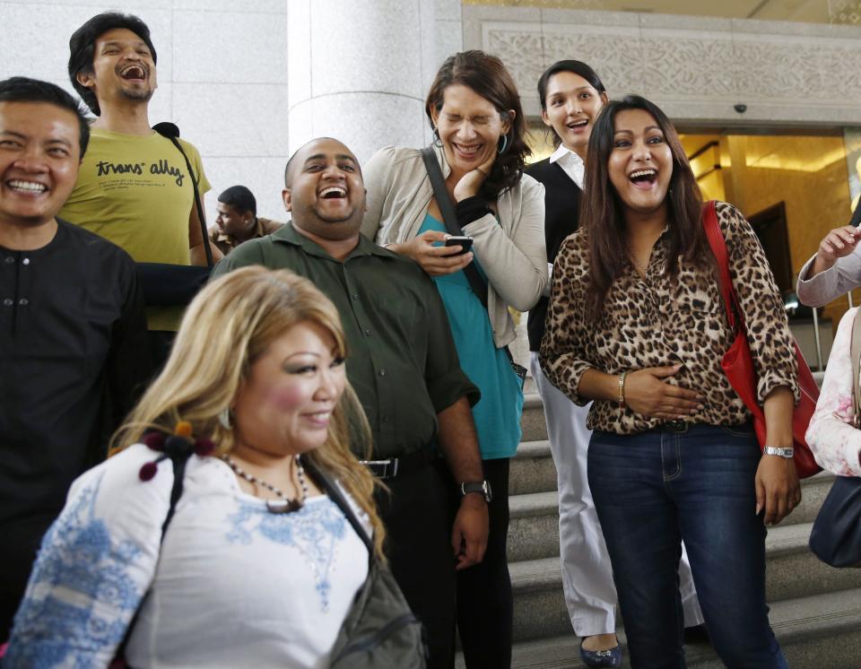 Activists celebrate overturning a sharia law against cross-dressing at the Appeals Court in the Palace of Justice in Putrajaya November 7, 2014. A Malaysian court on Friday gave transgender Muslims the right to cross-dress in a landmark decision to overturn an Islamic sharia law ban that could trigger similar challenges. REUTERS/Olivia Harris (MALAYSIA - Tags: POLITICS SOCIETY)