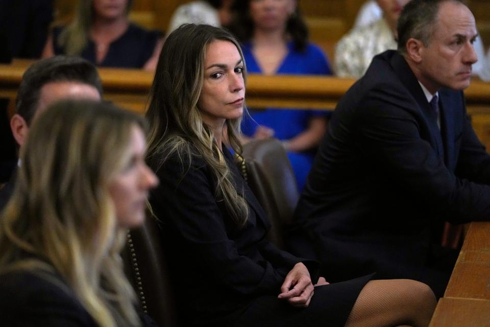 Karen Read watches as jurors are seated in court to continue with deliberations at the trial of Read at Norfolk Superior Court, Friday, June 28, 2024, in Dedham, Mass. Read, 44, is accused of running into her Boston police officer boyfriend with her SUV in the middle of a nor'easter and leaving him for dead after a night of heavy drinking. (AP Photo/Charles Krupa, Pool)