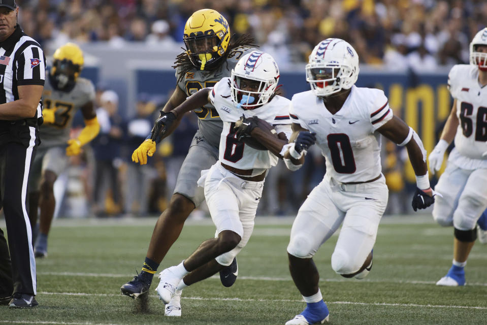 Duquesne's Keshawn Brown (6) carries the ball after a catch during the first half of an NCAA football game against West Virginia, Saturday, Sept. 9, 2023, in Morgantown, W.Va. (AP Photo/Chris Jackson)