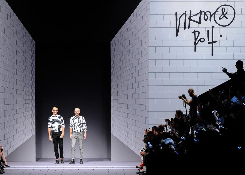 Fashion designers Viktor Horsting and Rolf Snoeren acknowledge applause the end of the Viktor and Rolf ready-to-wear Spring/Summer 2014 fashion collection, presented Saturday, Sept. 28, 2013 in Paris. (AP Photo/Zacharie Scheurer)