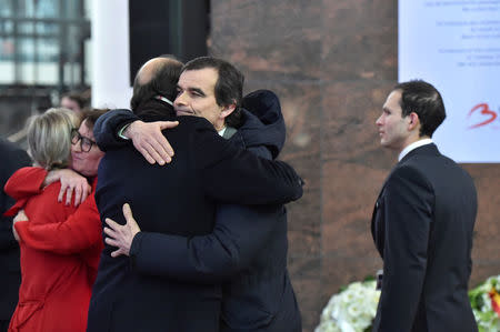 Member of the staff comfort each other during a ceremony at Brussels Zaventem airport, commemorating the second anniversary of twin attacks at Brussels airport and a metro train in Brussels, Belgium March 22, 2018. REUTERS/Eric Vidal