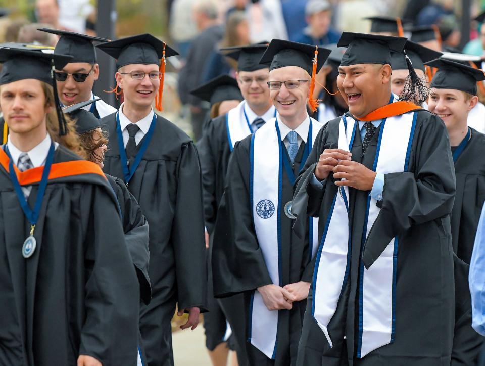 Graduates walk across campus during an academic procession at Utah State University’s commencement ceremony on Thursday, May 4, 2023, in Logan, Utah. | Eli Lucero, Herald Journal