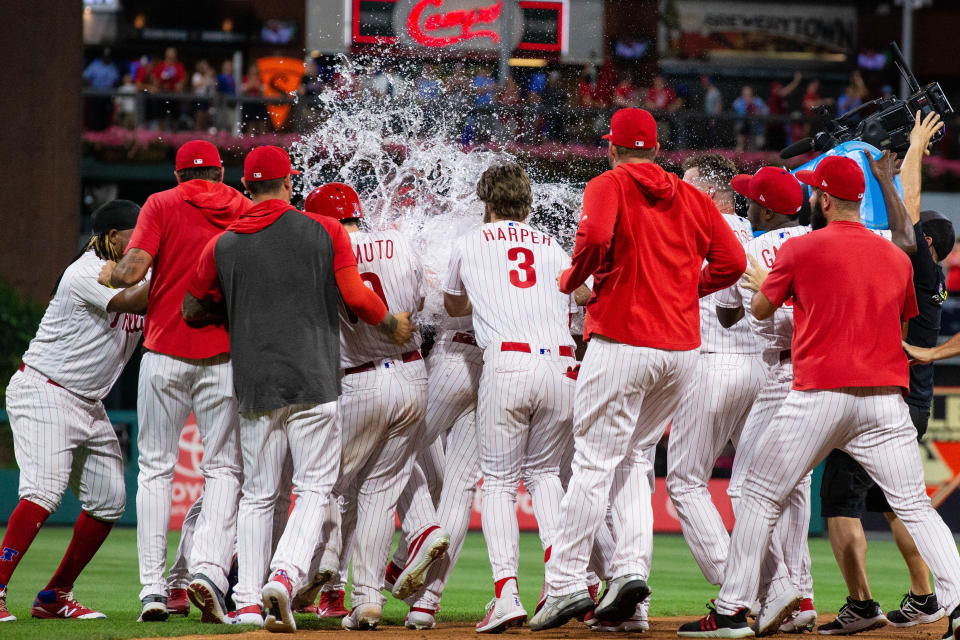 Jun 26, 2019; Philadelphia, PA, USA; Philadelphia Phillies right fielder Jay Bruce (23) is mobbed by his team after hitting a game winning RBI double during the tenth inning against the New York Mets at Citizens Bank Park. Mandatory Credit: Bill Streicher-USA TODAY Sports