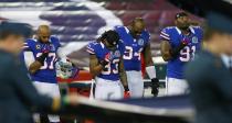 TORONTO, ON - DECEMBER 16: Players from the Buffalo Bills observe a moment of silence for the victims of the mass shooting at Sandy Hook Elementary School in Newtown, Connecticut, before a game against the Seattle Seahawks at Rogers Centre on December 16, 2012 in Toronto, Ontario, Canada. (Photo by Rick Stewart/Getty Images)