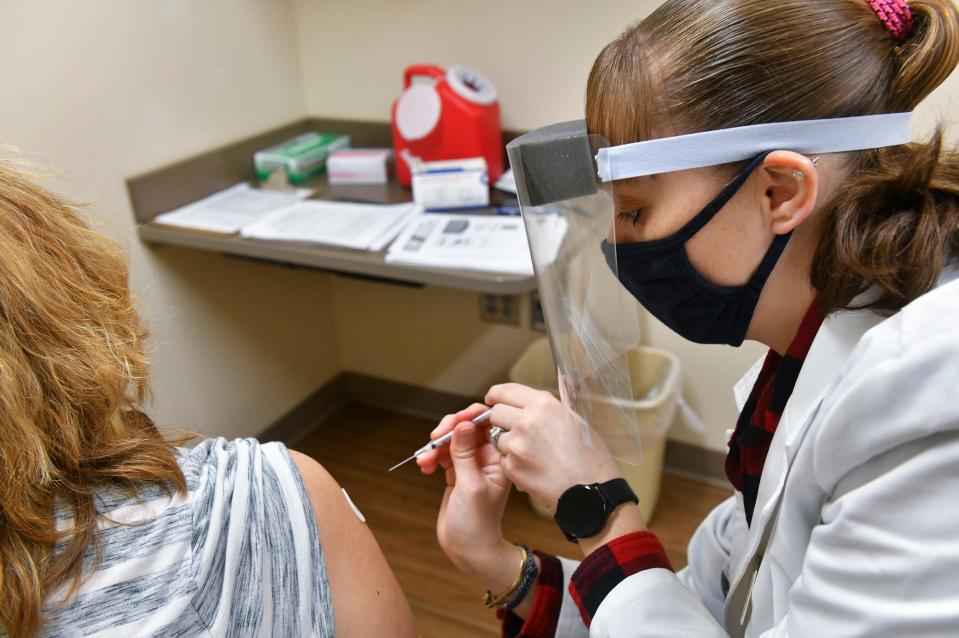 Larissa Yehle administers a dose of the Pfizer COVID-19 vaccine Friday, March 12, 2021, at Cash Wise pharmacy in Waite Park. 