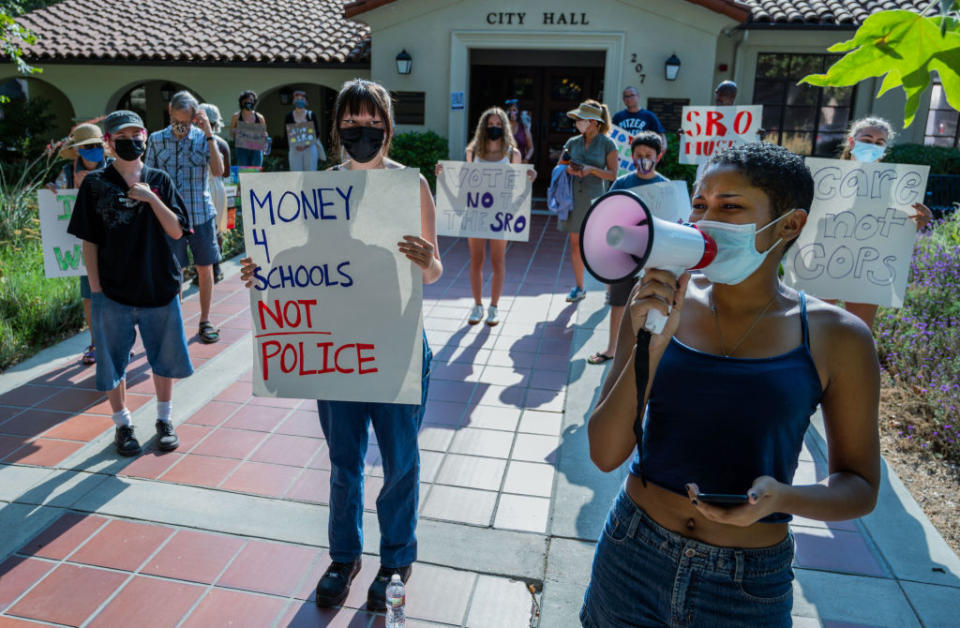 Claremont Student Equity Coalition member Jayla Sheffield uses a megaphone to lead chants during a June protest calling for education leaders in Claremont, California, to end the school resource officer program. (Terry Pierson / Getty Images)