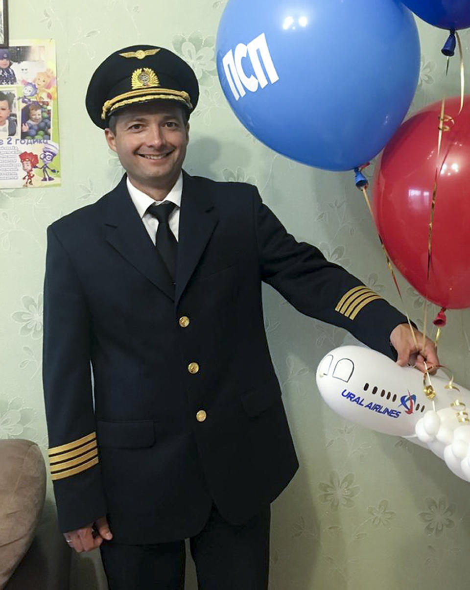 In this handout photo taken in 2018 and released by e1.ru , Damir Yusupov, 41, the captain of Ural Airlines A321pose for a photo in Yekaterinburg, Russia. The captain of a Russian passenger jet was hailed as a hero Thursday for landing his plane in a cornfield after it collided with a flock of gulls seconds after takeoff, causing both engines to malfunction. While dozens of people sought medical assistance, only one was hospitalized. (e1.ru via AP)