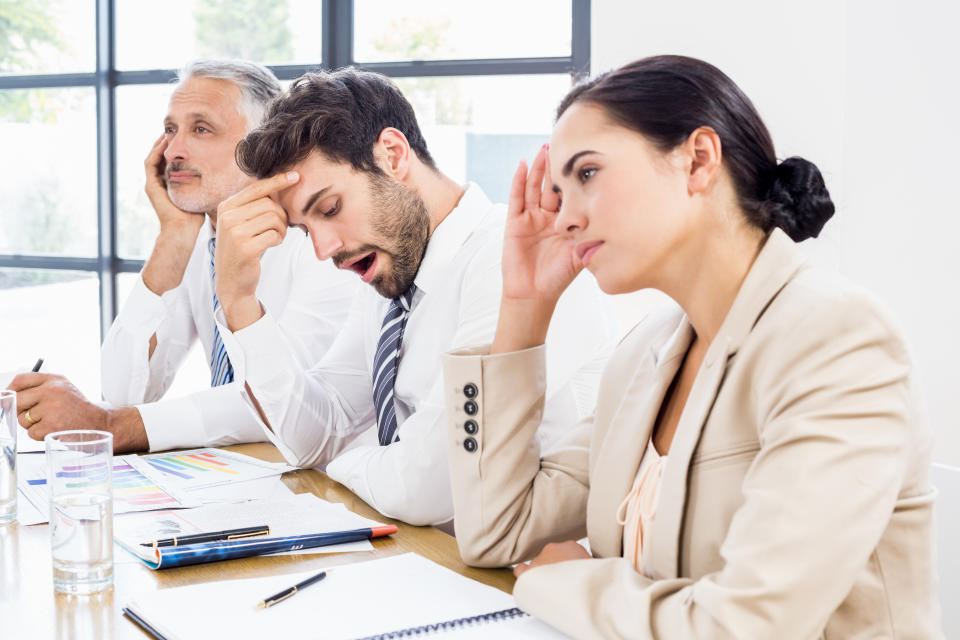 Business colleagues getting bored in a meeting at office