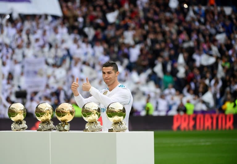 Real Madrid's Cristiano Ronaldo poses with his five Ballon d'Or trophies ahead of the Spanish league match against Sevilla