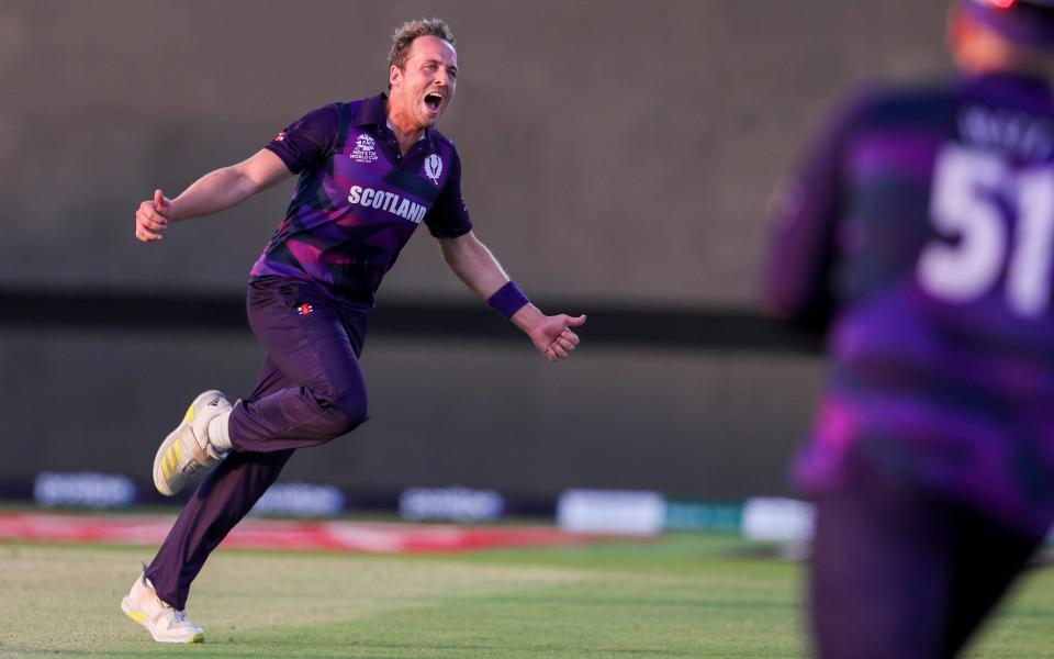 Scotland's Josh Davey celebrates taking the wicket of Papua New Guinea's Norman Vanua - AP