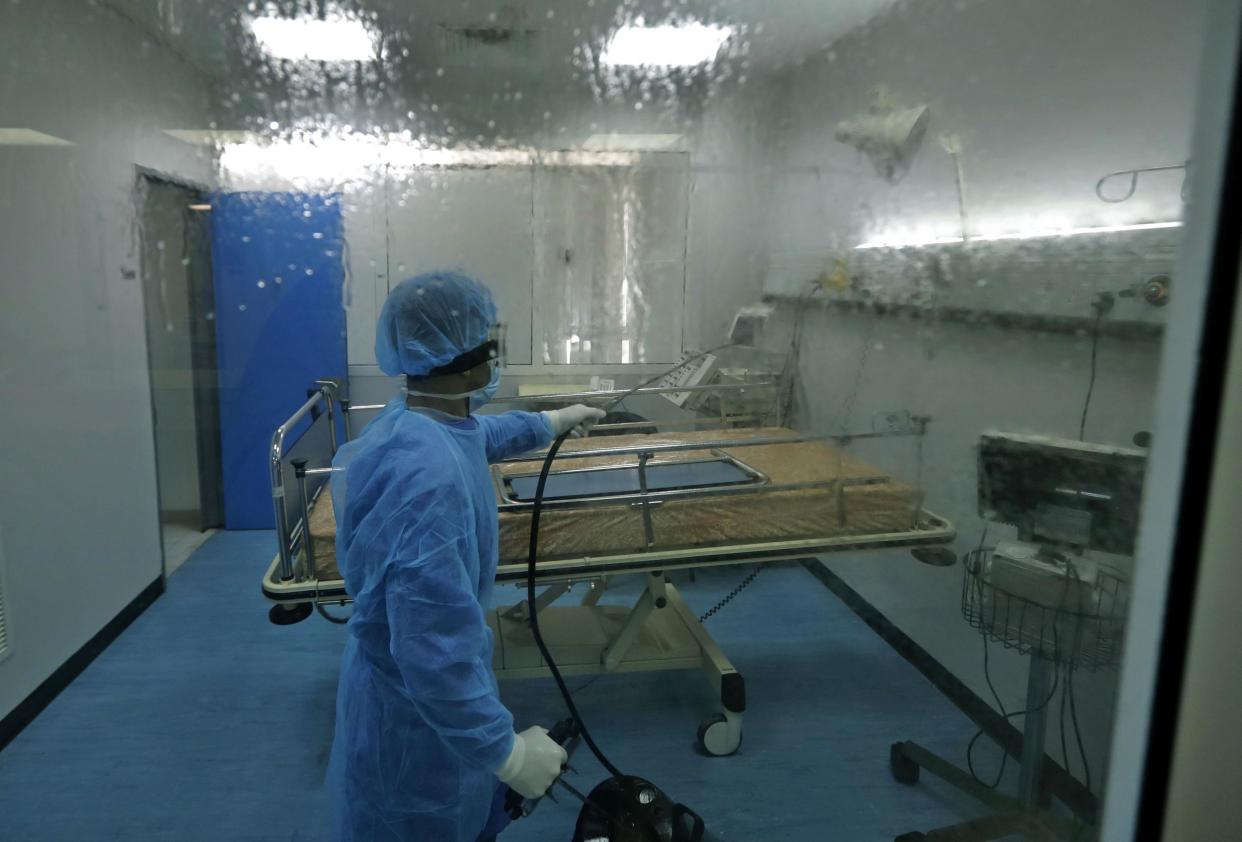 A man disinfects an intensive care isolation room at the Rafik Hariri public hospital in the Lebanese capital Beirut: Photo by JOSEPH EID/AFP via Getty Images